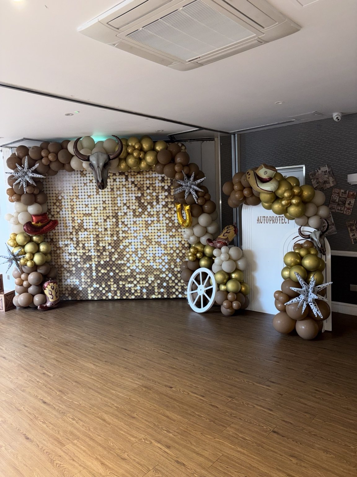 Western themed gold backdrop and balloons